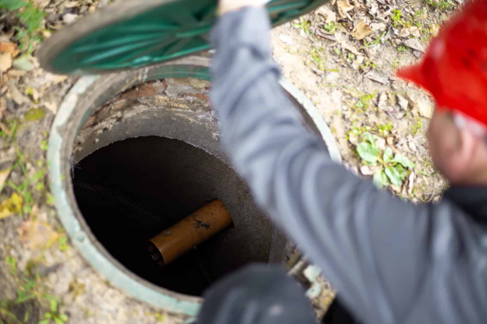 Worker inspecting a soakaway chamber during installation